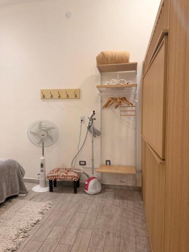 a room with a bed and a fan and a floor at Martita House in Clorinda