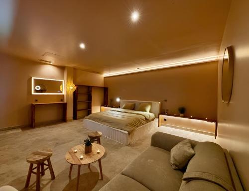 a living room with a couch and a bed at ExSPArience Private Spa Suite in Poitiers
