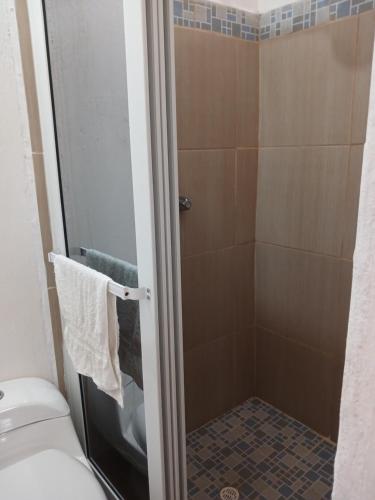 a bathroom with a shower and a toilet at Como en Familia in Esquipulas