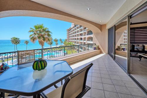 a table and chairs on a balcony with a view of the ocean at 3 Bedroom Beach Front at Sonoran Spa E410 in Puerto Peñasco