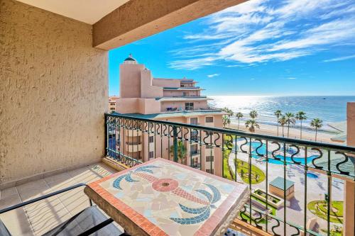 a balcony with a table and a view of the ocean at Oceanfront hideaway at Sonoran Spa N608 in Puerto Peñasco