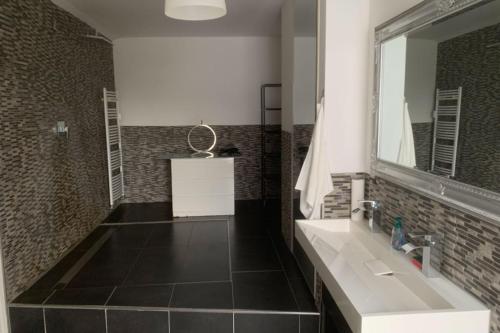 a bathroom with a sink and a mirror at Sleek Apartment in Troisdorf in Troisdorf