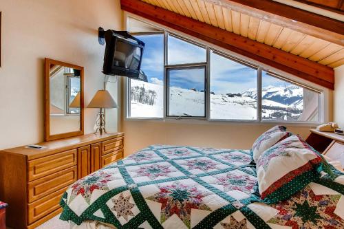 a bedroom with a bed and a tv and a window at Crested Butte Mountain Resort Properties by Vail Resorts in Crested Butte