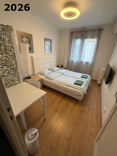 a small bedroom with a bed and a window at The NICE - 3 rooms, 3air cond, 3TV, 3fans, 2 wc, WIfi everywhere 5min aeroport, train, beach, 1min tram, 15 min centre, port, GARAGE FREE SECURITY in Nice