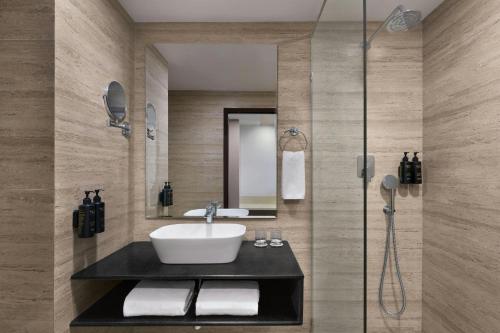 a bathroom with a sink and a shower at The Fern Residency Bengaluru, Yeshwanthpur, Series by Marriott in Bangalore