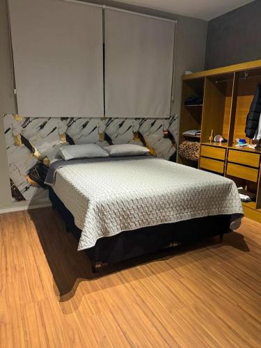 a bedroom with a large bed in a room at Home Tatuapé in São Paulo