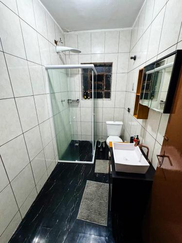 a bathroom with a shower and a toilet and a sink at Home Tatuapé in São Paulo