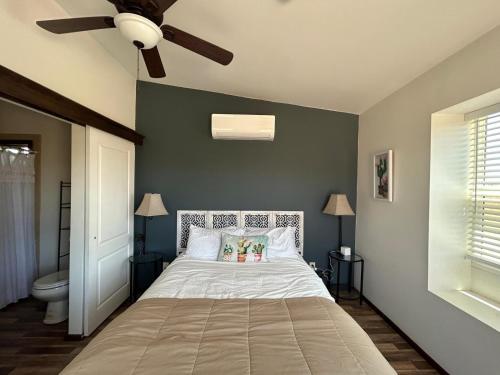 a bedroom with a bed and a ceiling fan at 3333 Luz Del Valle Hotel Boutique in Valle de Guadalupe