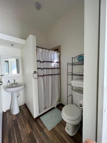 a bathroom with a toilet and a sink at 3333 Luz Del Valle Hotel Boutique in Valle de Guadalupe