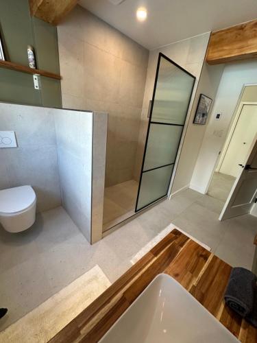 a bathroom with a tub and a toilet and a sink at Bear Valley Guesthouse in Stewart