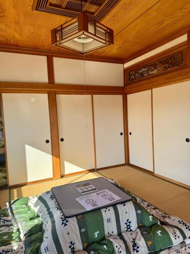 a room with a bed with a book on it at ANFT-shiro in Azumino