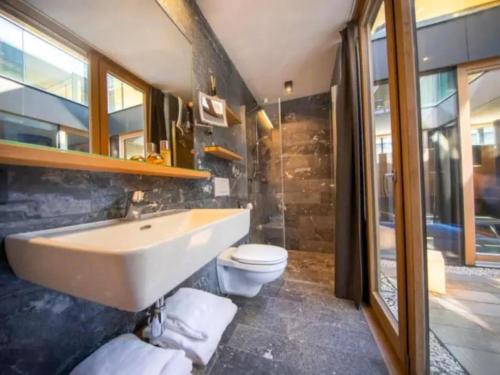 a bathroom with a sink and a toilet at Smaragdresort Gipfelstürmer in Brandberg