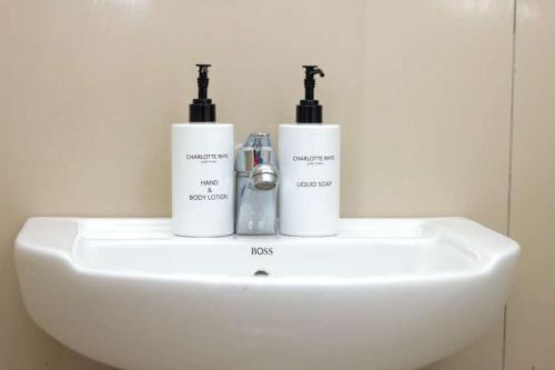 two bottles ofodorizers sitting on top of a sink at Alikho luxury accommodation in Abisai