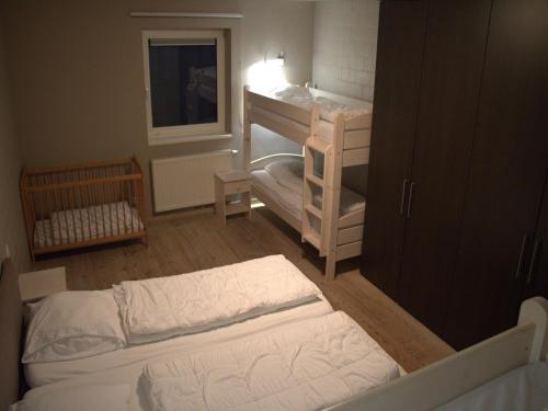 a small room with two beds and a sink at Countryside holiday home in Gijverinkhove