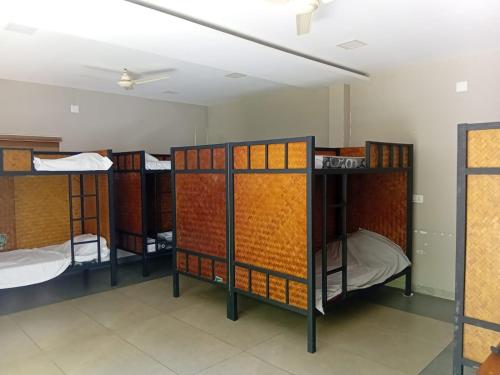 a group of bunk beds in a room at Maple grove villa resort in Panamaram