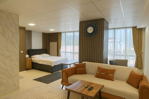 a hotel room with a couch and a bed at Nera Otel in Istanbul