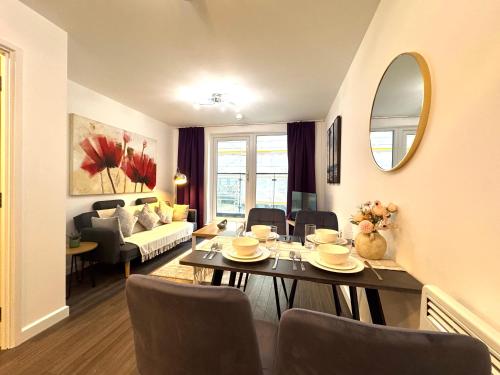 a living room with a table and chairs and a couch at VIPAbodes at The Nankeville Woking in Woking