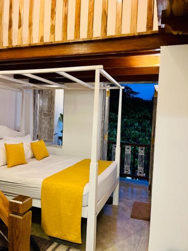 a bedroom with a bunk bed with yellow pillows at Ayubowan Home in Galle