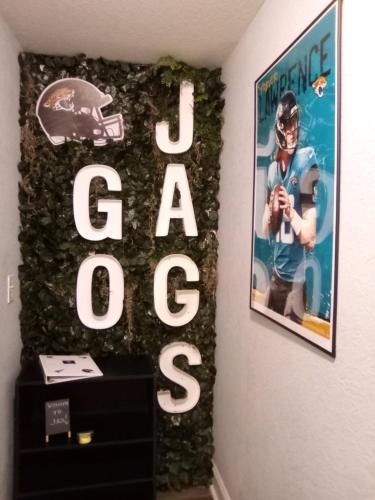a sign for a football game on a wall at The Jax Hideout in Jacksonville