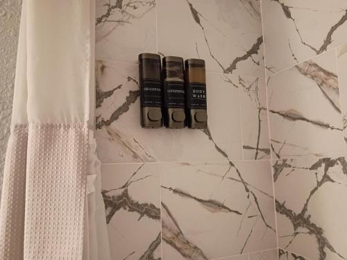 a bathroom with three bottles of essential oils on a wall at The Jax Hideout in Jacksonville