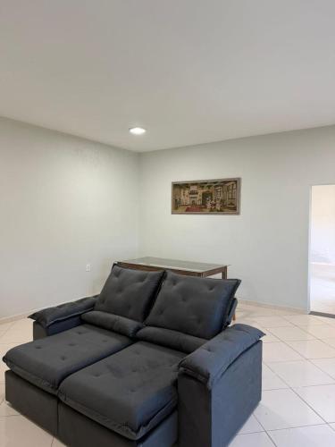 a blue couch sitting in a living room at Casa Guriri in São Mateus