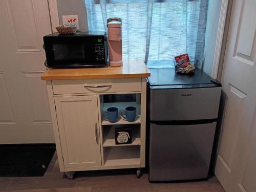a kitchen with a microwave and a coffee maker at The Jax Hideout in Jacksonville