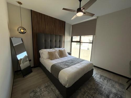 a bedroom with a bed and a ceiling fan at Private Room w/ Ensuite Bath & top Amenities in La Cañada
