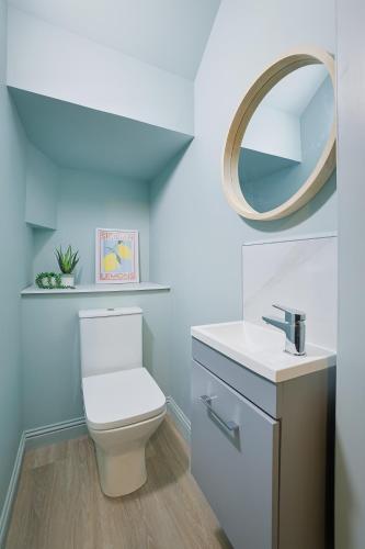 a bathroom with a white toilet and a mirror at Gordon's Getaway Lux in Oban