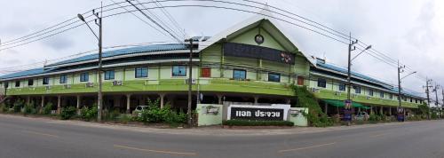 a green building on the side of a street at แอทประจวบ-At Prachuap in Prachuap Khiri Khan
