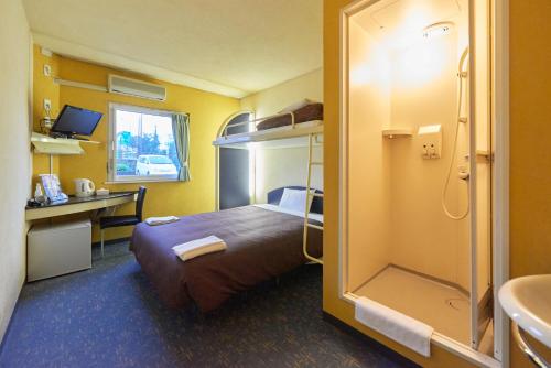 Postel nebo postele na pokoji v ubytování Select Inn Numazu