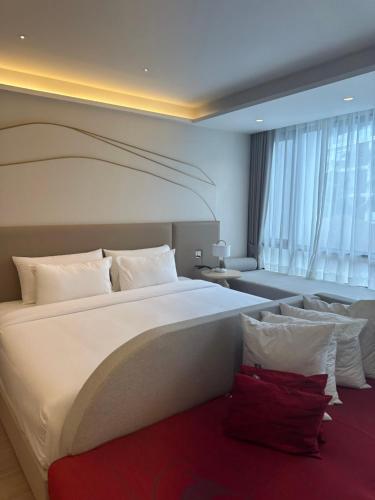 a bedroom with a large white bed and a couch at Wyndham studio 2205 in Surin Beach