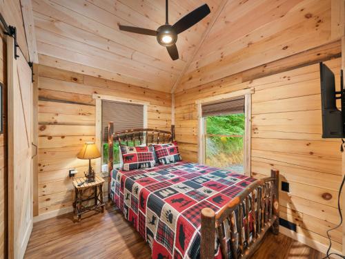 a bedroom with a bed in a log cabin at The Three Dog Night Cabin in Bryson City