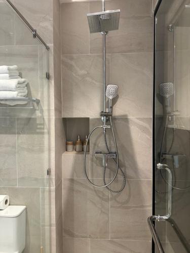 a shower with a glass door in a bathroom at Wyndham studio 2205 in Surin Beach
