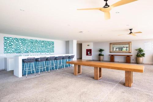 a dining room with a table and stools at Luxurious apartment in cruz de huanacaxtle with covered parking in Cruz de Huanacaxtle