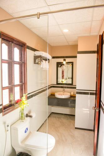 a bathroom with a toilet and a sink at Viva Beach Resort Mui Ne in Mui Ne
