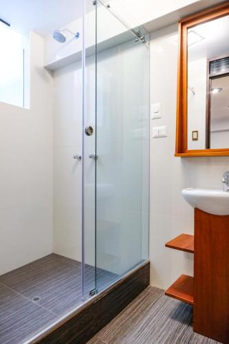 a glass shower in a bathroom with a sink at Ayra Hotel Boutique in Pisac