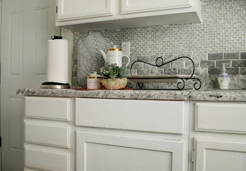 a kitchen with white cabinets and a counter top at Eden's Cozy Oasis in Windsor