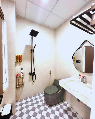 a bathroom with a sink and a toilet and a mirror at Max Home in Ninh Hải