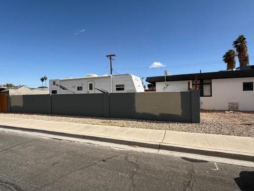 a fence on the side of a street next to a house at RV 2 min to Las Vegas Strip in Las Vegas