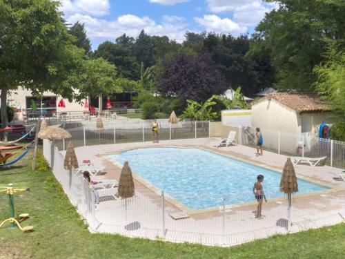 a large swimming pool with people standing around it at Chalet Confortable avec Terrasse - 5 pers - API-1-52-1957 in Pamiers