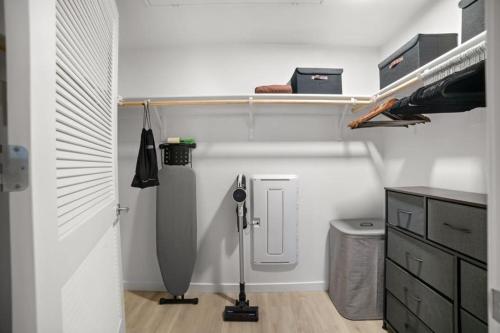 a room with a closet with a shelf and a door at Modern Lux Midrise Stadium & Downtown Views in West Sacramento