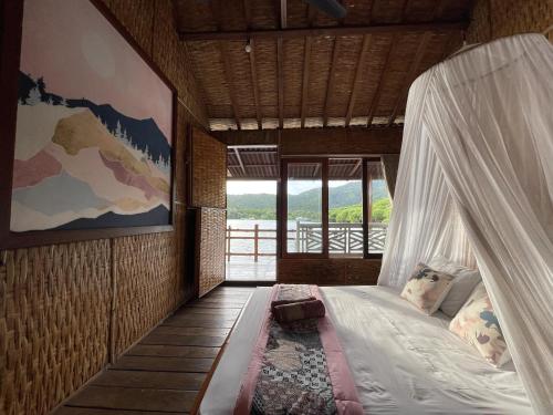 a bedroom with a bed in a room with a window at Floating Paradise in Karimunjawa