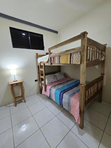 a bedroom with a bunk bed and a tv at The Stone Way Suite in Juayúa