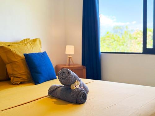 a stuffed animal is laying on a bed at Quiet house - great mountain view in Tiaraha