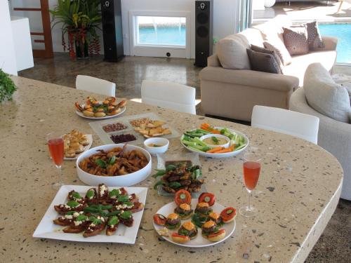 a table with plates of food and wine glasses at Vacala Bay Resort in Matei