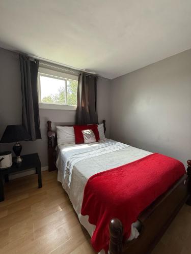 a bedroom with a large bed with a red blanket at 197 Le Maire Street in Winnipeg