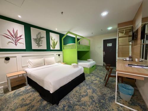 a bedroom with a bed and a desk and a sink at Asto Hotel Kuala Lumpur in Kuala Lumpur