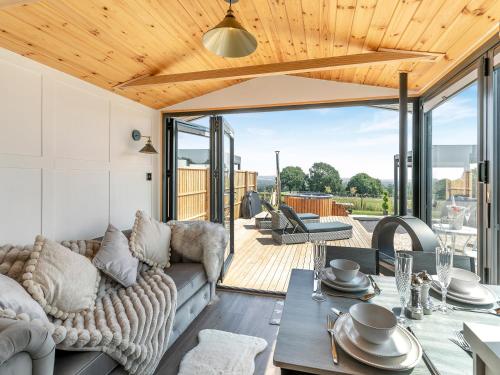 a living room with a couch and a table at Barn Owl Lodge - Uk49903 in Appley Bridge