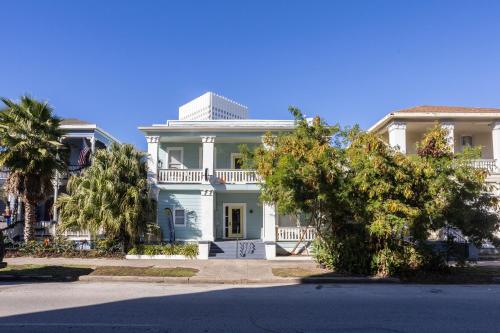 a large white house with trees in front of it at Church GTX in Galveston