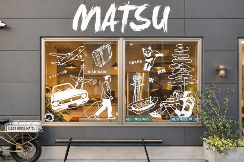 a mitzvah sign on the side of a store window at Guest House Matsu in Osaka